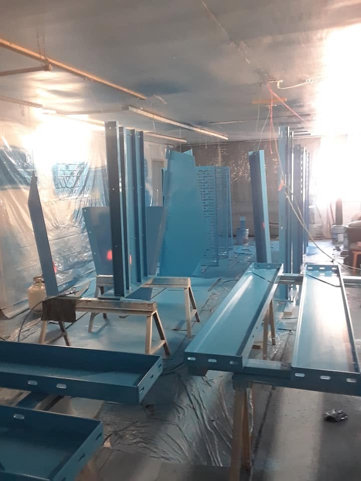 Steel finish-coated in blue inside a fully masked spray booth
