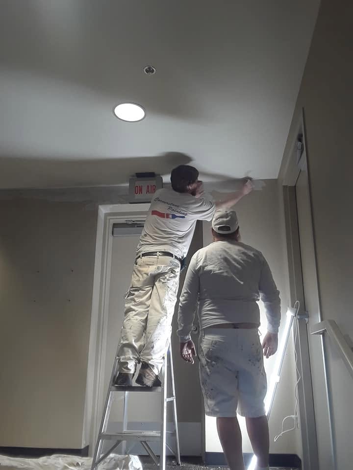 Cornerstone painter cutting in at the ceiling line inside the Orpheum Theater