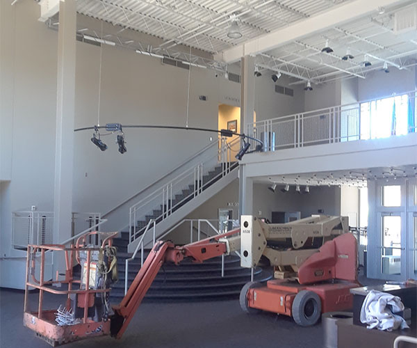 High-ceiling commercial lobby, painted from powered lifts.